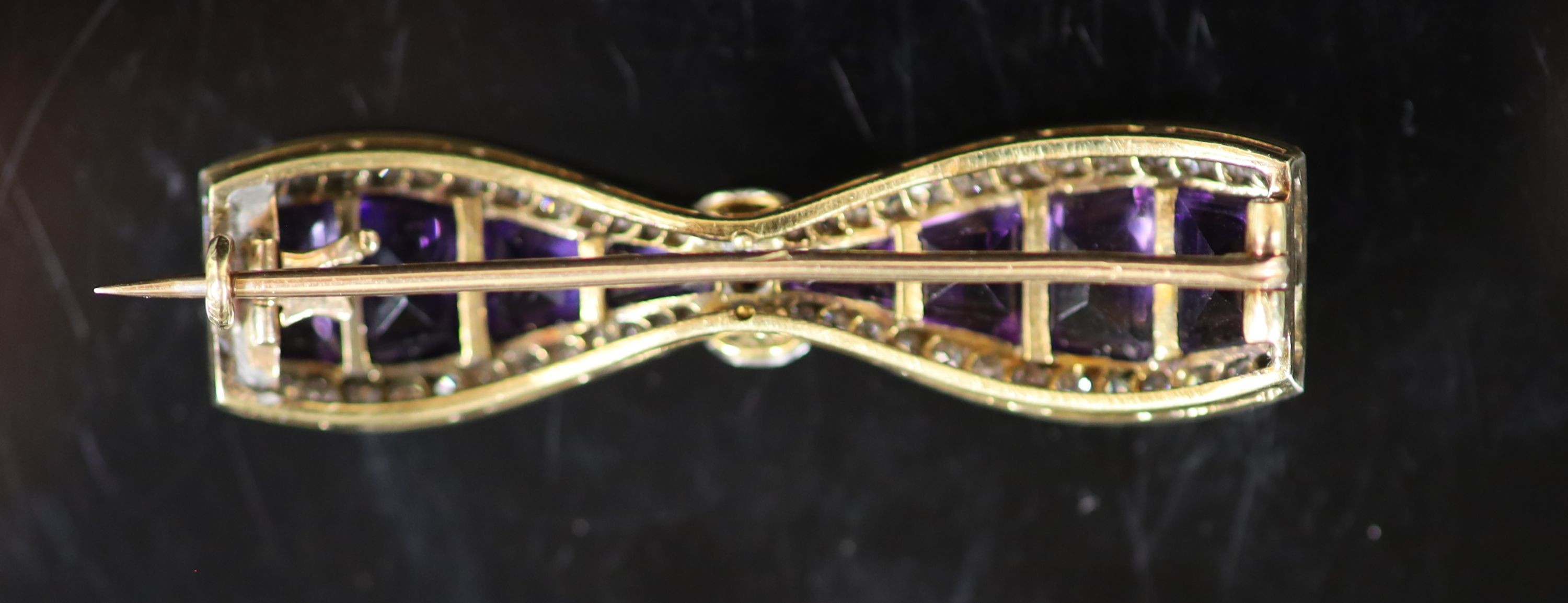 A 20th century gold and platinum, amethyst and millegrain diamond set 'bow tie' brooch